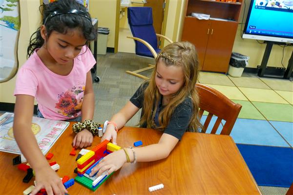 student with colorful blocks